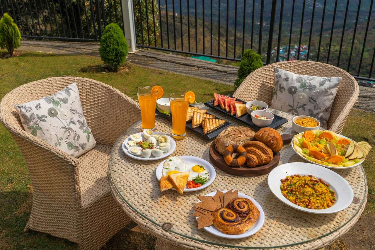 Breakfast laid out on a round cane table on the lawn