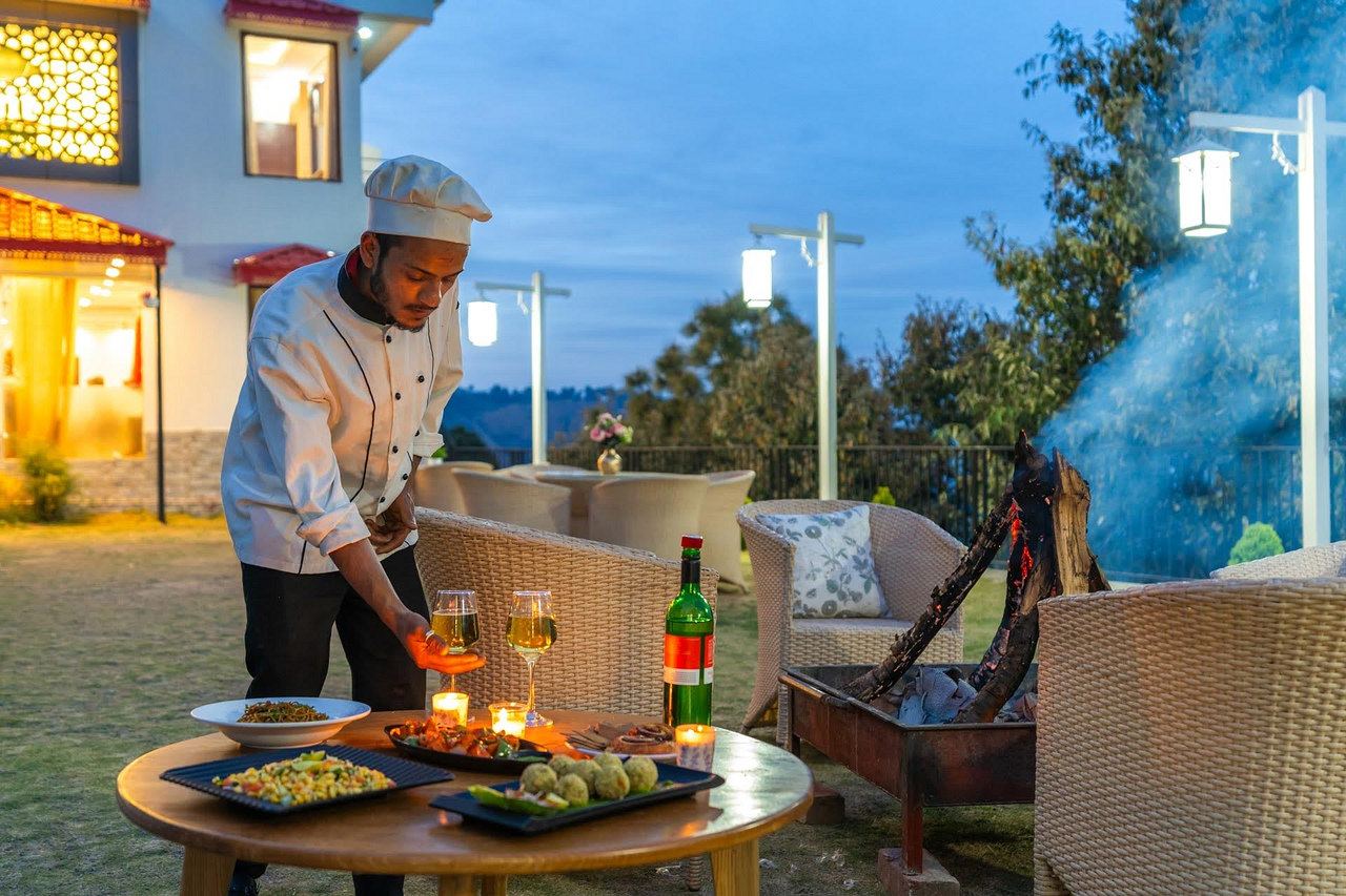 A cook at the fire pit at dusk