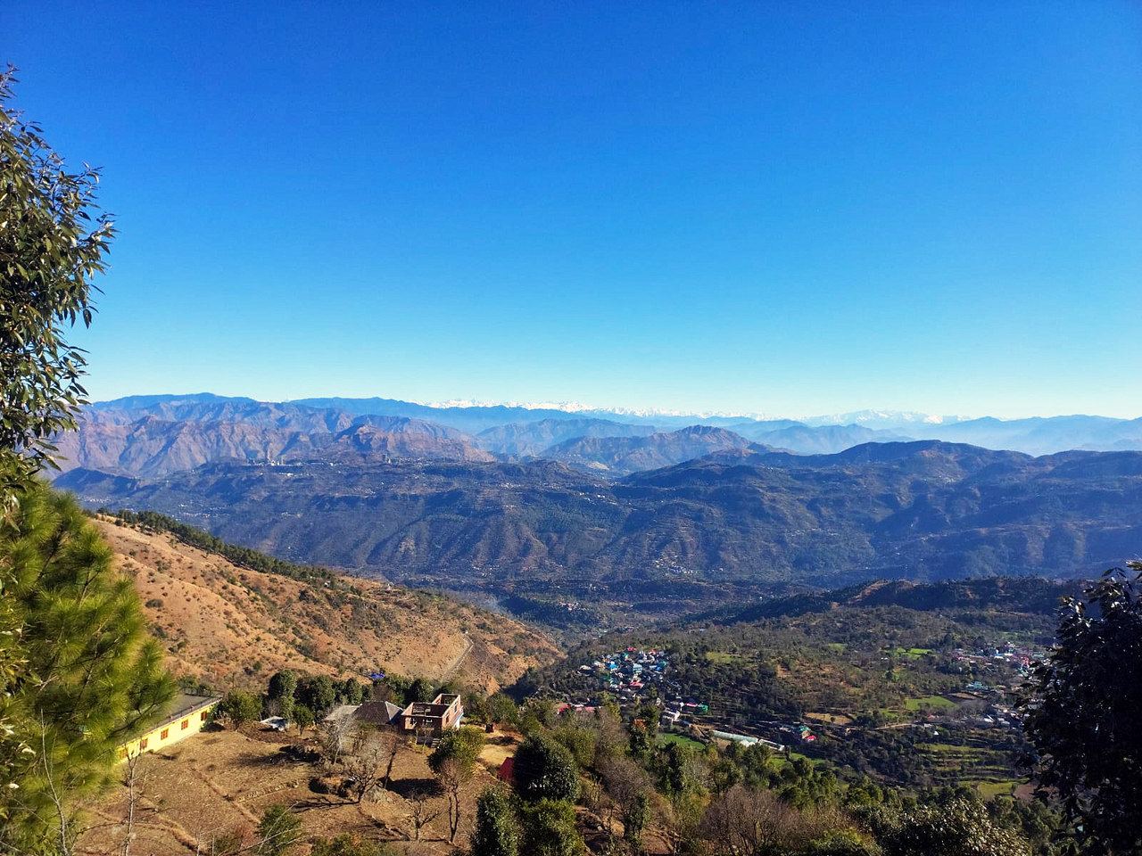 A deep blue sky over the valley and the far ranges