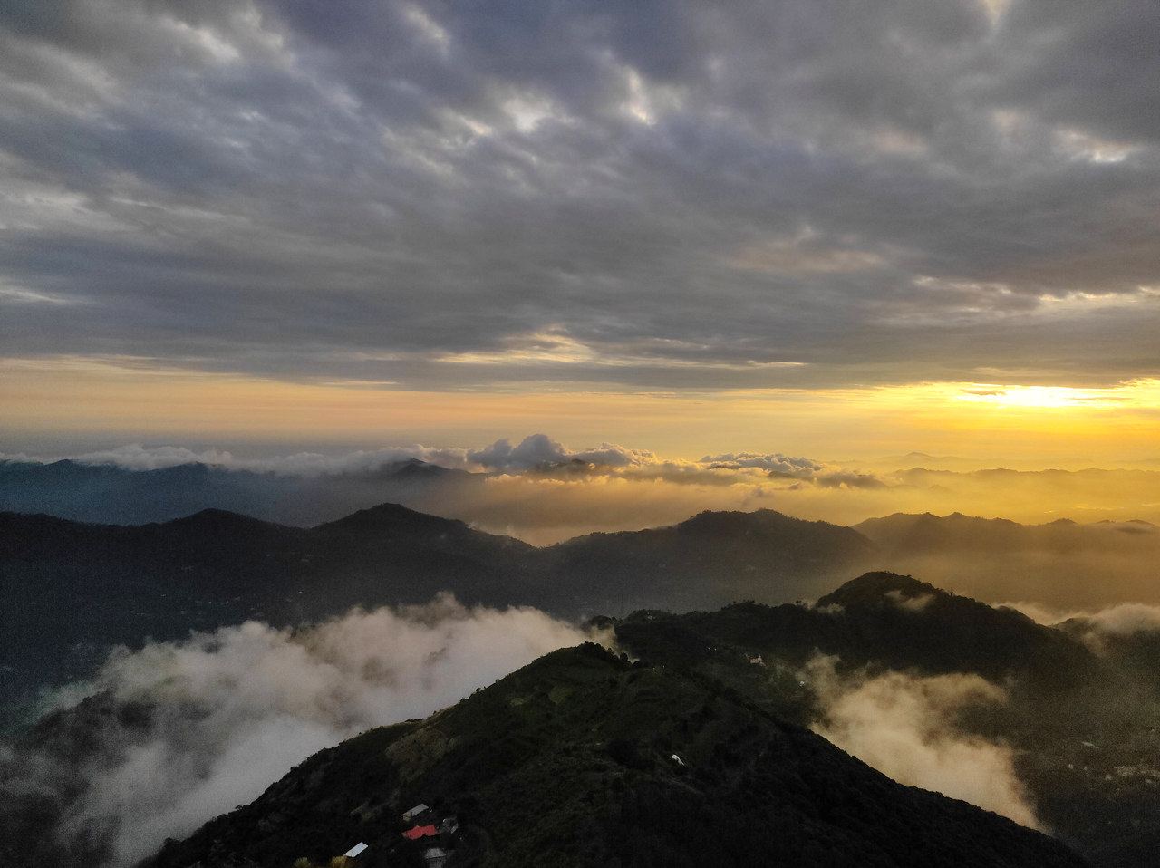 Clouds in the valleys at sunset, seen from the ridge