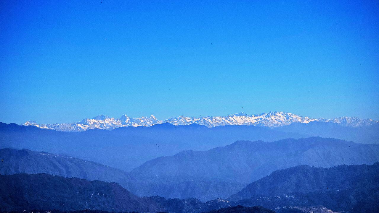 Snow peaks of the Himalaya at first light above the ridges