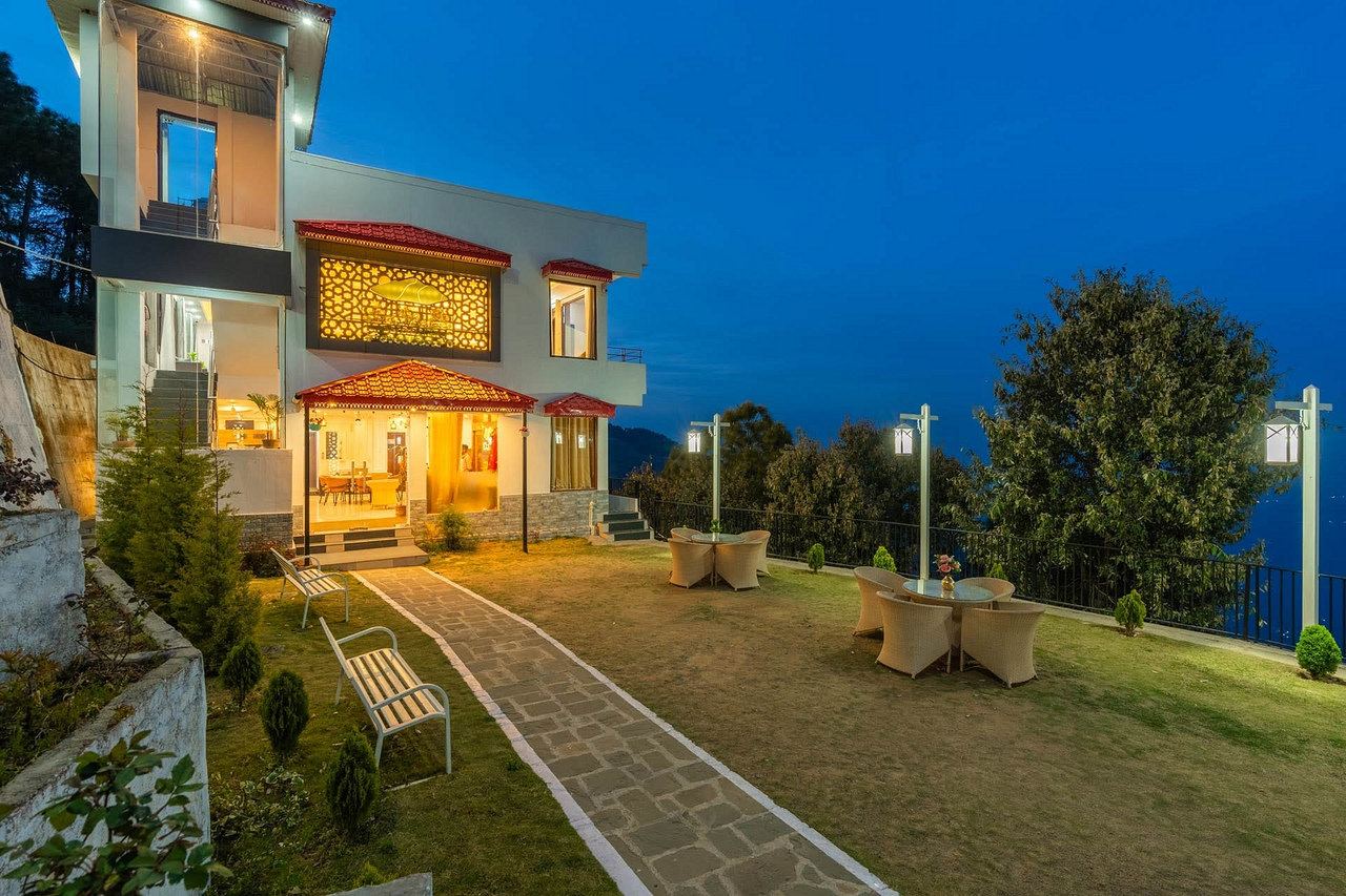 The path from the lawn to the front of the building at dusk, lit and welcoming