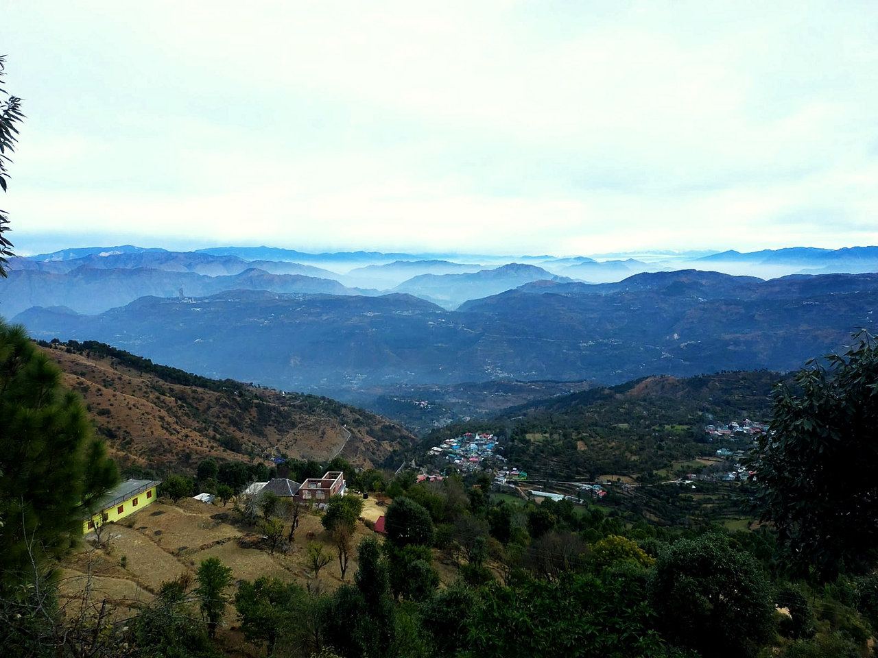 Hills and a village in the valley, with a clear sky